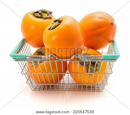 Persimmon Sharon in a shopping basket isolated on white background