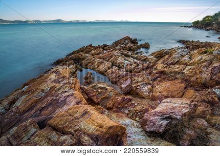Sea wave impact with rock streak like a boil water with clear sky, Khao Leam Ya National Park at Rayong of Thailand (Long Exposure Technique photograph)