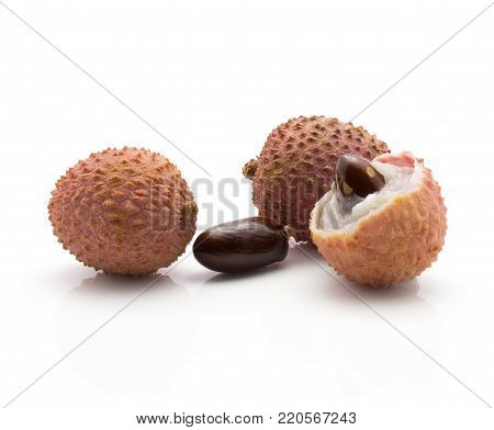 Three lychee berries isolated on white background ripe pink fresh two whole one peel with seed inside and one separated dark brown seed