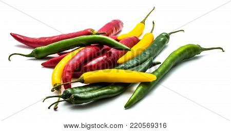 A lot of Chili peppers isolated on white background three colors red green yellow