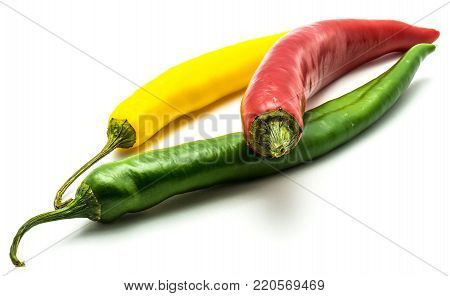 Red, green and yellow Cayenne Chili peppers isolated on white background whole