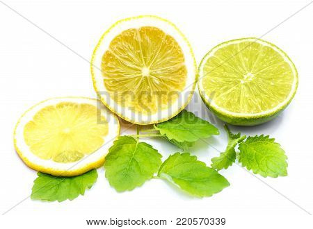 Lemon half and slices with fresh lemon balm leaves isolated on white background