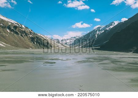 beautiful mountain valley with lake and snow capped peaks on Indian Himalayas, Ladakh region