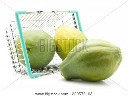 Green papaya  out a shopping basket isolated on white background three whole fresh