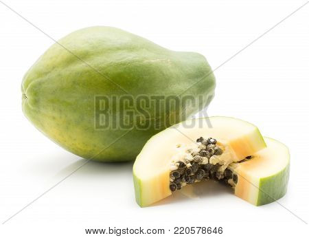 Green papaya (pawpaw, papaw) and two slices isolated on white background