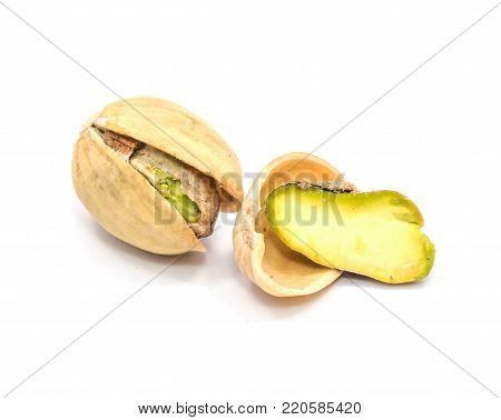 Pistachio nuts isolated on white background, one open, one half in shell