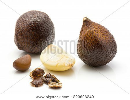 Salak isolated on white background two whole snake fruit one peel clove one seed and skin