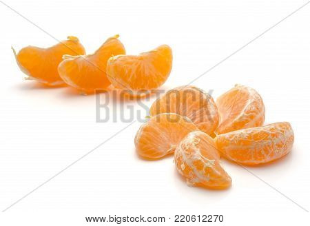 Tangerine segments gathered in flower and in row isolated on white background