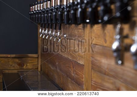 Beer filling equipment. Beer store. Defoamers on a wooden surface