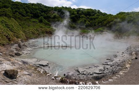 The hot water of Oyunuma pond in the volcanic landscape of Hell Valley (Jigokudani), Noboribetsu, Hokkaido, Japan