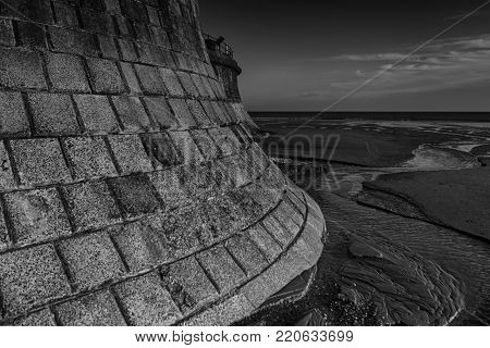 Filey sea wall with the tide out and streams running to the sea
