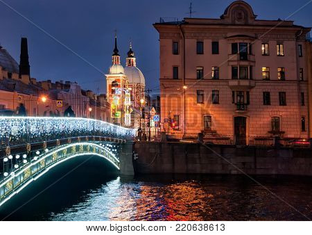SAINT - PETERSBURG, RUSSIA - JANUARY 2, 2018: New Year decoration on The Panteleymonovsky bridge over The Fontanka River. On the background is St Panteleimon Orthodox Church on Pestel Street
