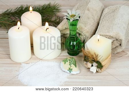 Winter spa concept with candles. Aromatherapy treatmen, bath crystals on wooden background.