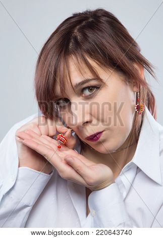 Portrait of woman with necklace on gray background