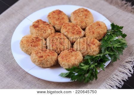 Fried Cutlets On A White Plate On A Table On A Gray Background.