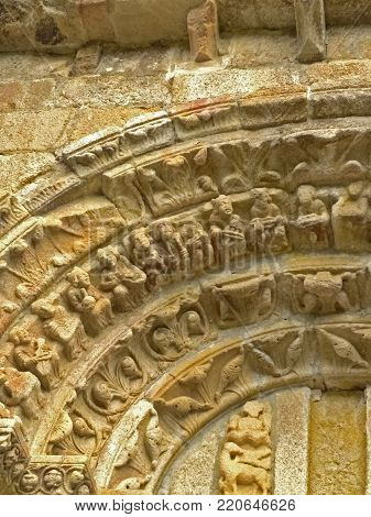 Tympanum. Carboeiro, Silleda, Pontevedra, Spain. 04/29/2017: Detail of a compostelano Romanesque church in rural Galicia. A representation of a Christian biblical episode appears: several elders of the Apocalypse with their musical instruments.