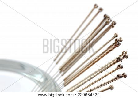 Silver needles for traditional Chinese medicine acupuncture. isolated on white background. Close-up.