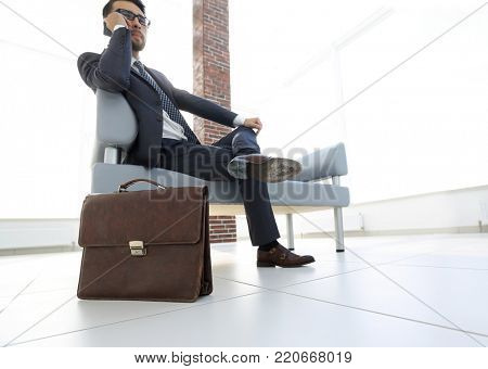 businessman holding his briefcase in office