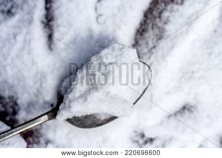 Common Salt,sodium Chloride In A Wooden Scoop On Wooden Floor.