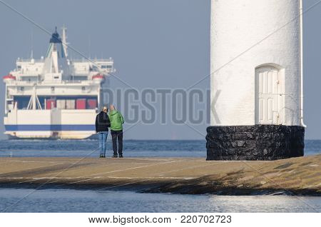 PASSENGER-CAR FERRY - ship sails into the sea from seaport