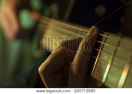 Handsome young men playing guitar on the concert