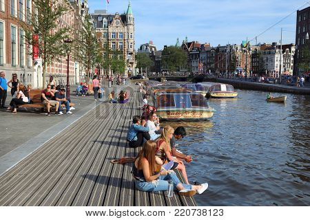 Amsterdam, Netherlands - July 9, 2017: People Visit Rokin Canal In Amsterdam, Netherlands. Amsterdam