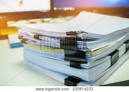 Stacks of documents files for finance of office working.Business report papers or Piles of unfinished document achieves with black clip paper. Concept of Business Annual Report.