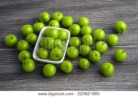 most notable green sour plums, mouth watering sour plums, white background sour plums,