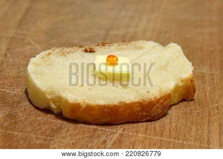 Sandwich for poor people who have not a money with small piece of butter and only one grain of red caviar