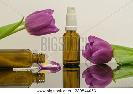 Globulin for natural homeopathy medicine isolated on neutral background with tulips
