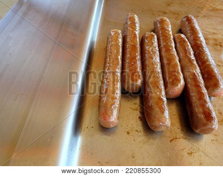 BBQ sausages cooked on a outdoor hot plate
