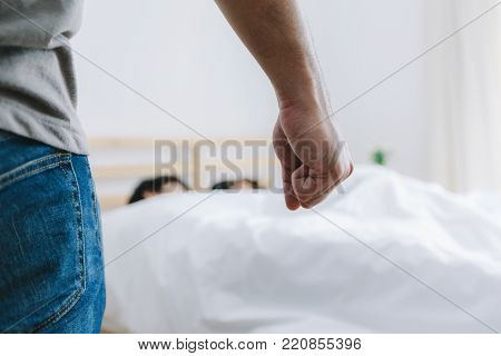 Husband is angry with his wife lying with another man. Paramour concept.