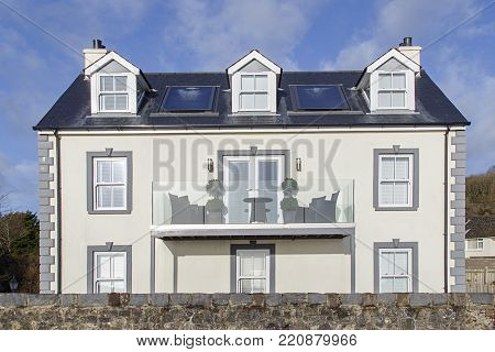 Amroth, UK: January 01, 2018: A large detached newly built house with a balcony on the coast road through the seaside village of Amroth in South Wales.