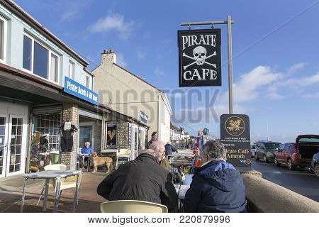 Amroth, Wales, UK: January 01, 2018: Customers wait to be served in the Pirate Cafe on the beachfront cafe in Amroth. The customers are out for a walk on a winters day and are wearing warm clothing.