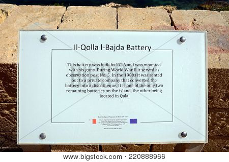MARSALFORN, GOZO, MALTA - APRIL 3, 2017 - Information sign for the Il-Qolla I-Badja battery, Redoubt, Marsalforn, Gozo, Malta, Europe, April 3, 2017.