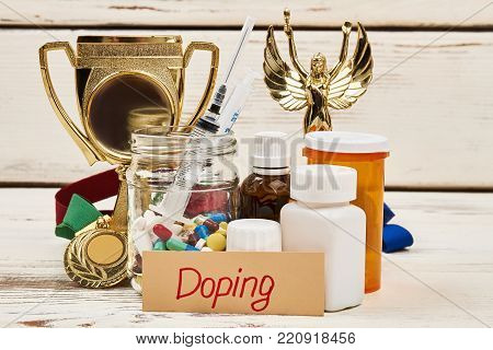 Doping medications and trophy. Drugs to enhance athletic performance. Unfair victory and crime in sports.