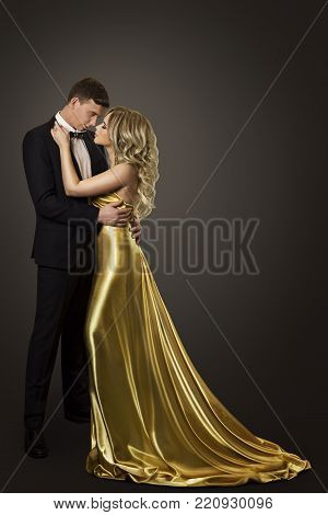 Fashion Couple Beauty Portrait, Kissing Man and Woman, Well Dressed in Golden Dress and Black Suit