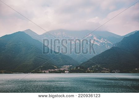 Italy view of a mountain lake lago di summer in cloudy weather.