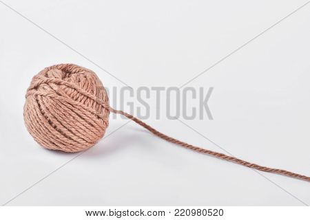 Ball of yarn on white background. Tangle of knitting brown yarn isolated on white background.