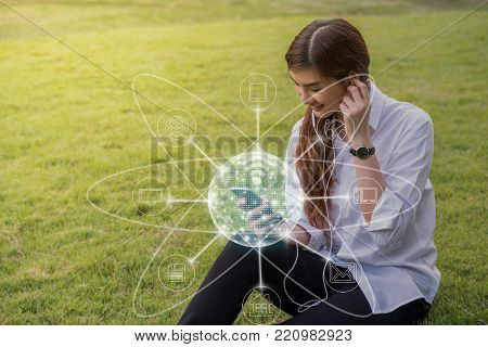 Happy asian Beautiful young woman listening the song and using the social network via smart mobile phone for online shopping with omni channel in the park, lifestyle and technology concept, 3D illustration