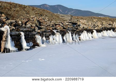 Iced remains of an old wooden pier in the settlement of Bolshoe Goloustnoye. Russia, Lake Baikal