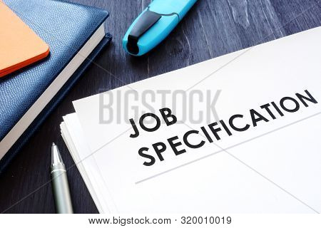 Job Specification On The Black Desk And Pen.