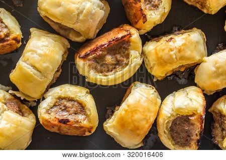 Mini Cocktail Sausage Rolls On Baking Tin Out Of Oven - Top View