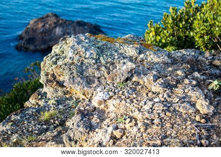 Exotic Cliff Rock, Background Sea 

Light Brown Color Rocks And Cliff, Waves Hitting The Rocks