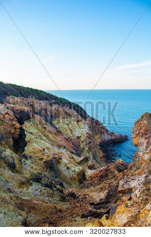 Exotic Cliff Rock, Background Sea 

Light Brown Color Rocks And Cliff, Waves Hitting The Rocks