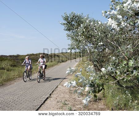 Norderney, Germany, 25 August 2019: People Enjoy Nature By Riding Bicycle On The German Island Of No