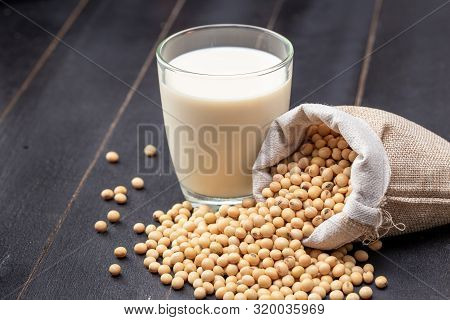 Soy Milk And Soybean On Dark Wooden Background