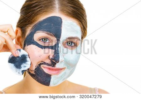 Woman With Clay Carbo Black Mask On One Half Face And White Mud On Second Half. Girl Removing Cosmet
