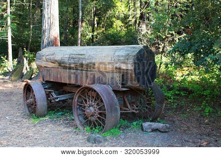 Vintage Wagon Loaed With Huge Log In Leggett, California