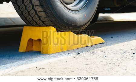 Camper Leveling Yellow Block In Use. Leveler Ramp Chock Blocks For Rv Travel Trailer. Accessories Fo